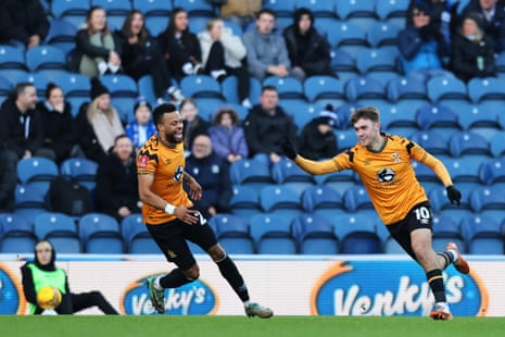 Jack Lankester of Cambridge United (right) celebrates after opening the scoring at Blackburn Rovers.