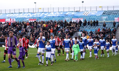 Gillingham's Jake Turner and teammates walk out onto the pitch before the match against Sheffield United.