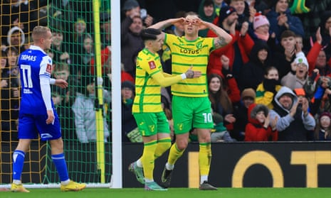 Norwich City’s Ashley Barnes makes a goggles gesture as he celebrates with Borja Sainz after opening the scoring against Bristol Rovers.