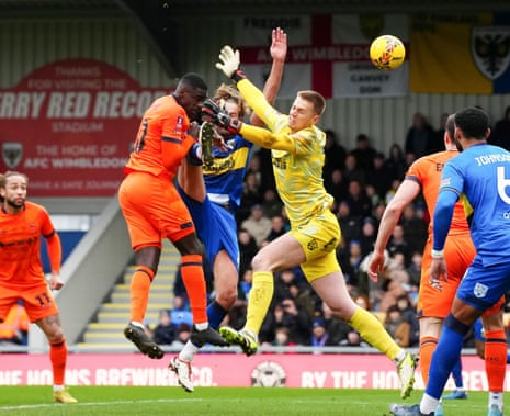 Axel Tuanzebe of Ipswich Town scores the second goal past Harry Pell and AFC Wimbledon goalkeeper Alex Bass.