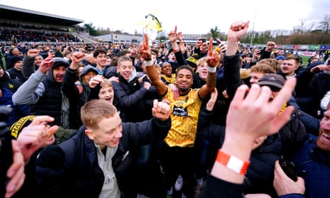 Maidstone United's Liam Sole celebrates on the pitch with fans at the end of the FA Cup third round victory over Stevenage.