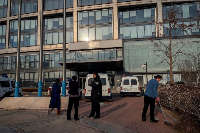 A police officer outside Zhongzhi’s headquarters in Beijing