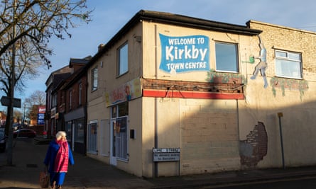 ‘Welcome to Kirkby town centre’ is written on a mural on the side of a two-storey building