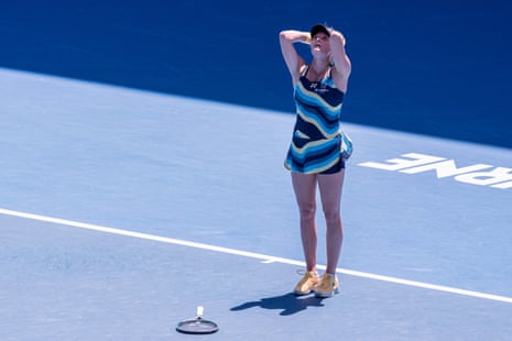 Dayana Yastremska puts her hands behind her head and looks up after winning match point