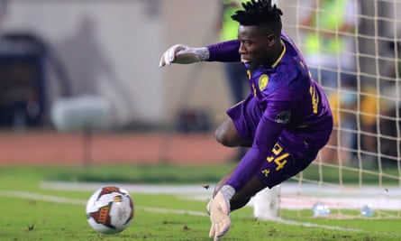 André Onana of Cameroon saves a penalty from Burkina Faso’s Blati Toure in the 2022 Africa Cup of Nations third place penalty shootout.