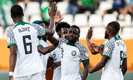 Nigeria’s Moses Simon (centre) is congratulated for his whipped cross that Opa Sanganté turned into his own goal