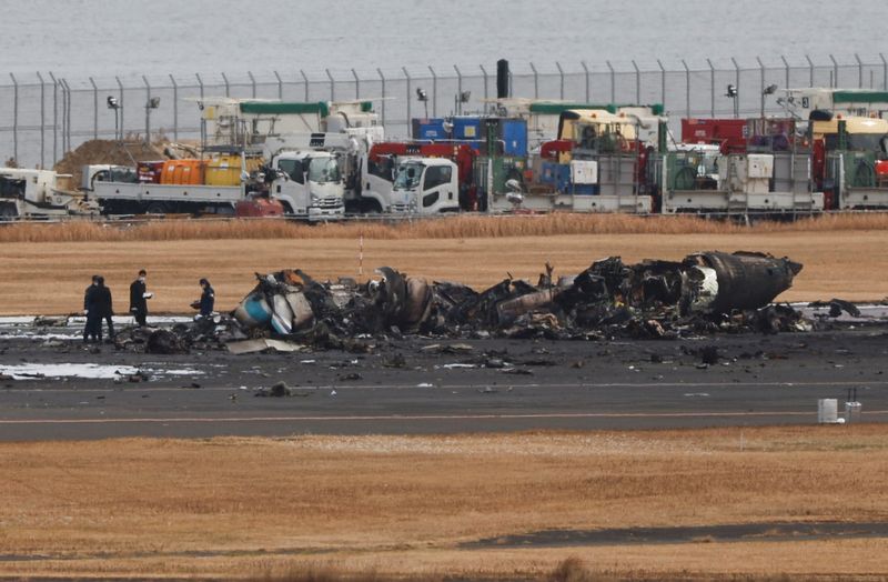 Crews begin clearing plane wreckage from Japan runway collision