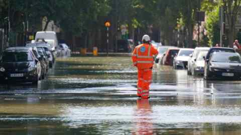 Thames Water worker in a flooded street