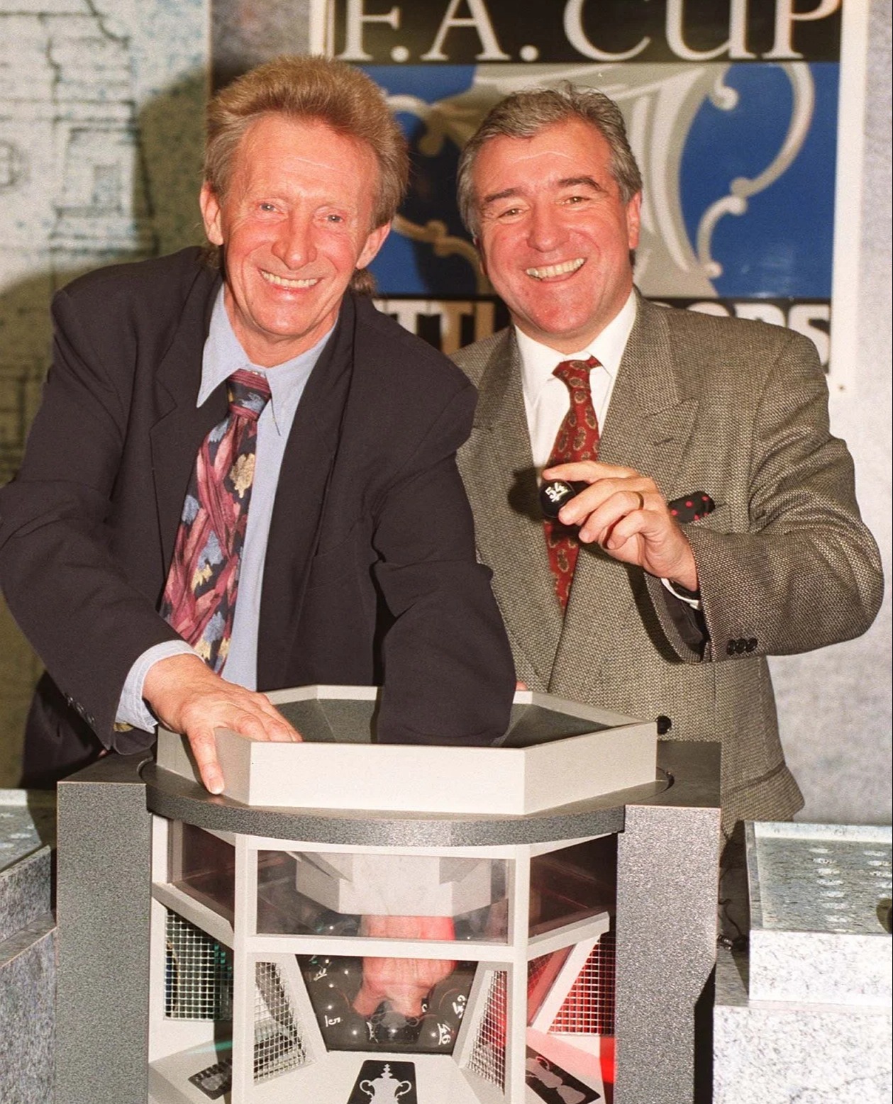 Denis Law and Terry Venables perform the FA Cup draw in 2000