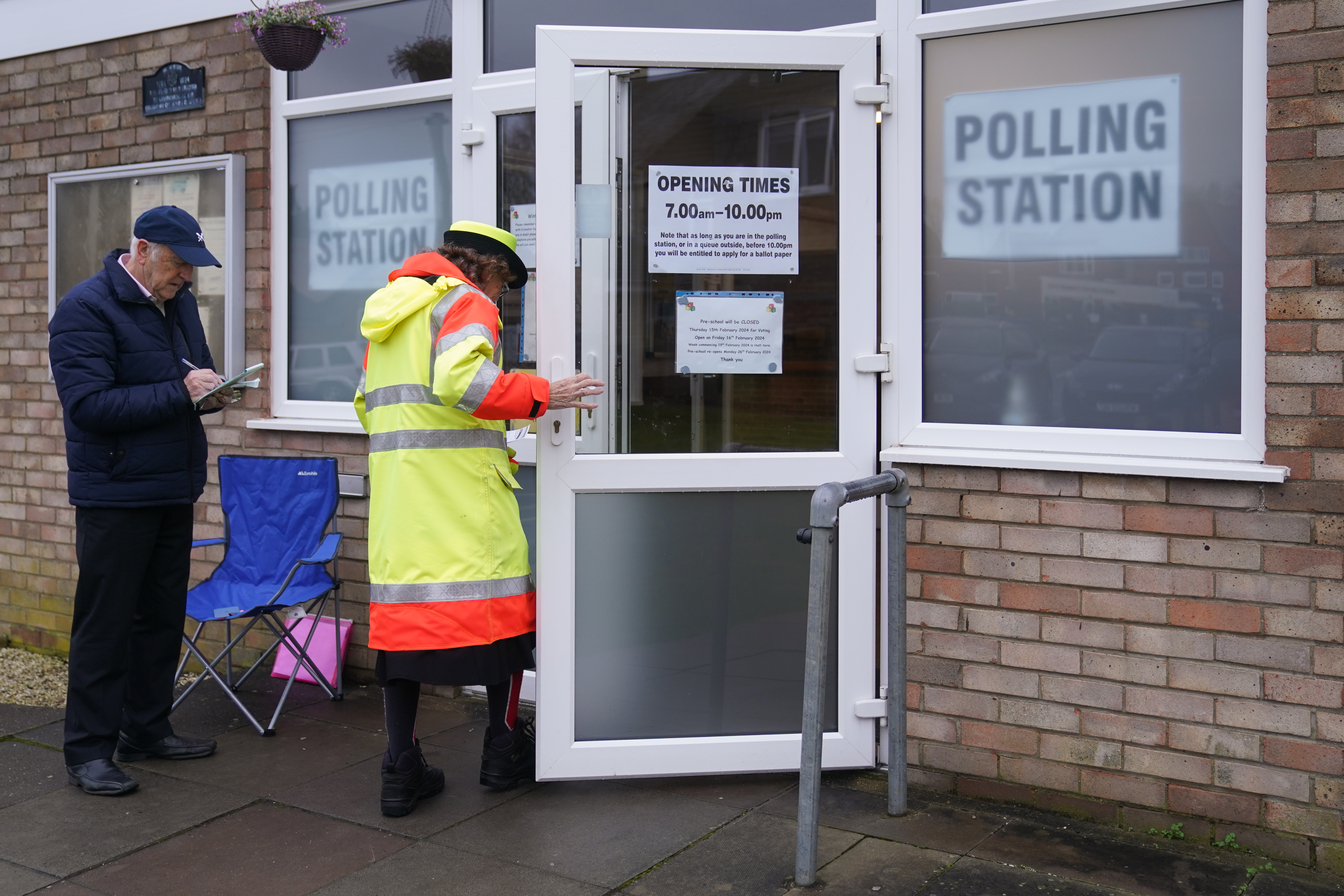 People arrive at Irchester Village Hall, as voting gets underway in the Wellingborough by-election