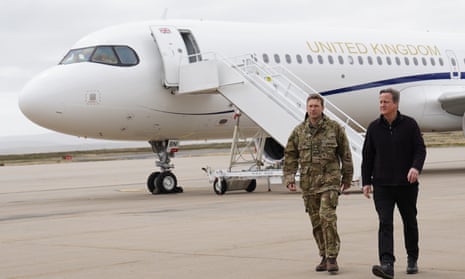 Foreign Secretary Lord David Cameron (right) arrives at Mount Pleasant airbase on the Falkland Islands, during his high-profile visit to demonstrate they are a "valued part of the British family" amid renewed Argentinian calls for talks on their future.