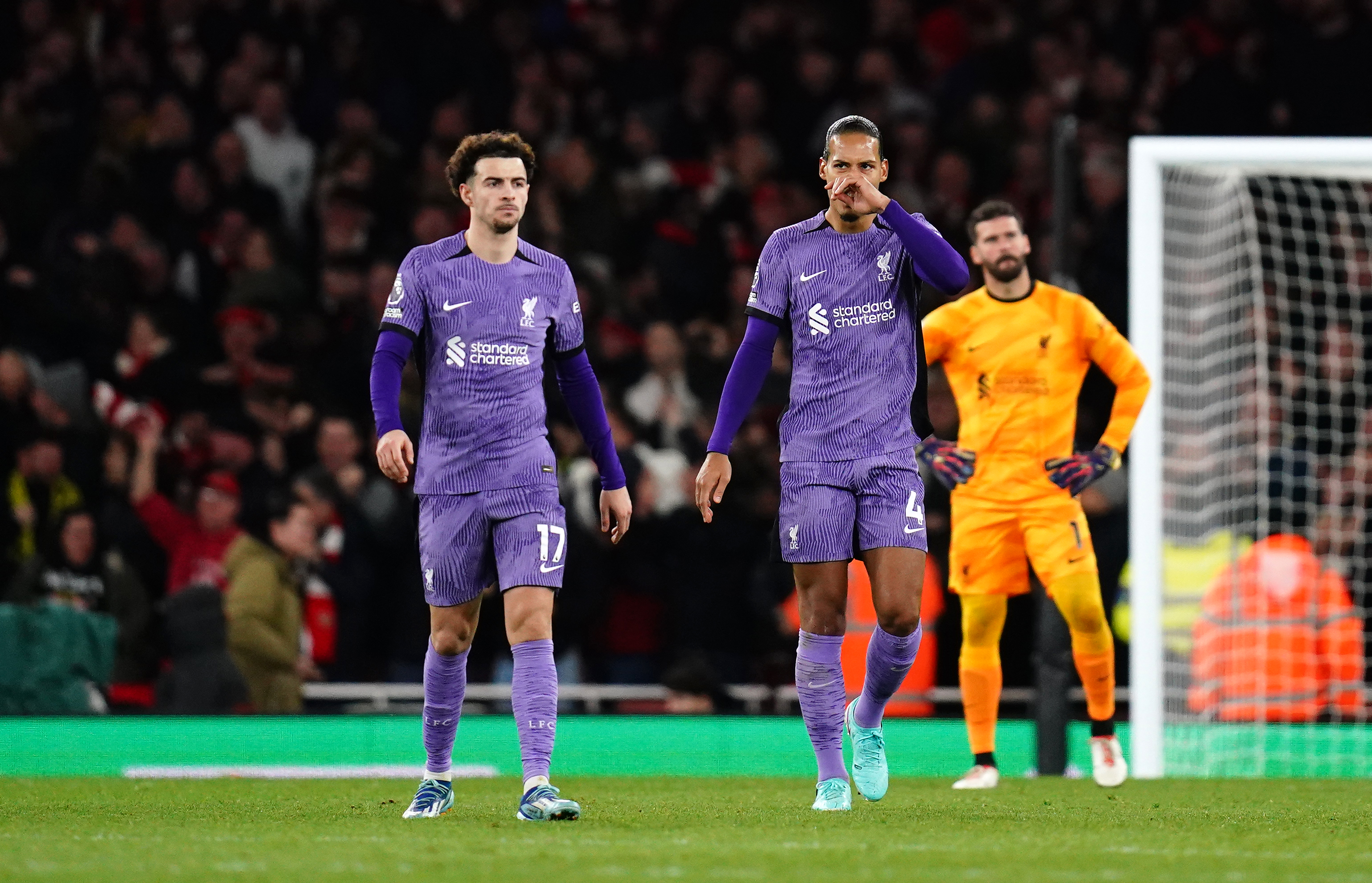Curtis Jones, left, reflects with Virgil van Dijk and keeper Alisson Becker after the howler that let in Gabriel Martinelli to restore Arsenal's lead