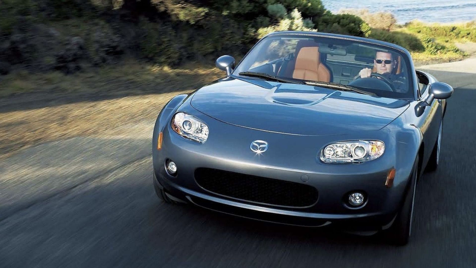 2006 Mazda Miata - Gray - front view - driving on coastal road