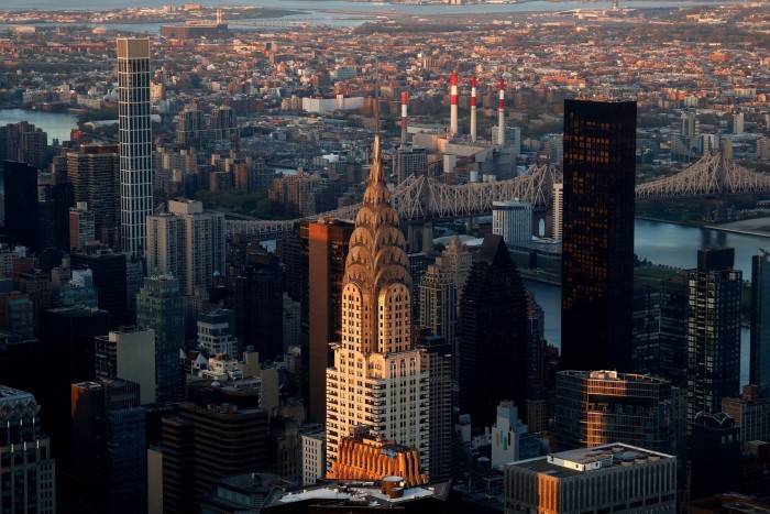 The sun sets on the Chrysler Building as seen from the 102nd-floor observation deck at the Empire State Building in New York City