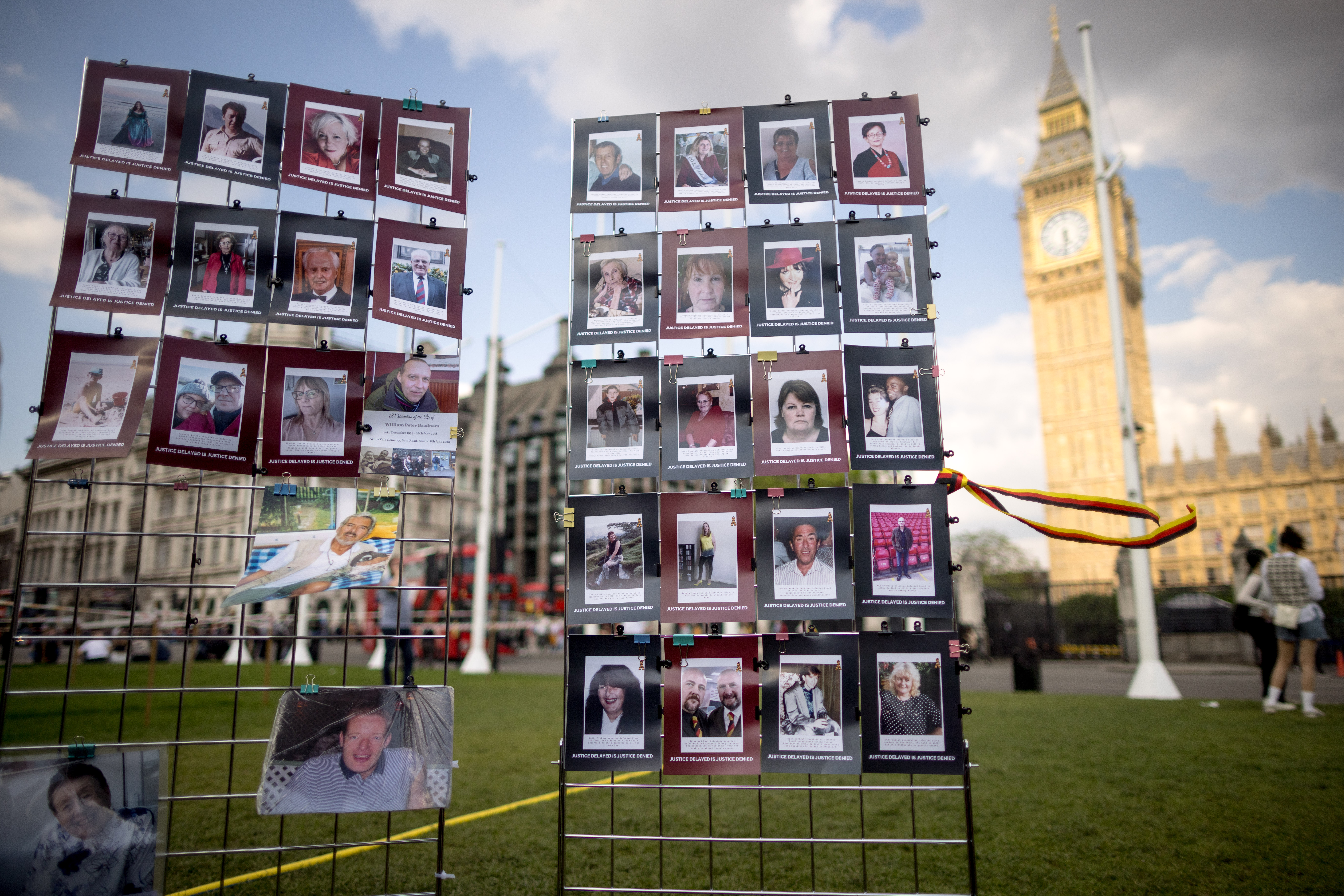  Pictures of those that died after receiving infected blood are displayed during a vigil in Parliament Square on May 19, 2024 in London