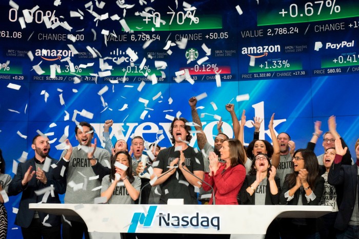 Adam Neumann, centre, co-founder and chief executive of WeWork, attends the opening bell ceremony at Nasdaq in New York in January 2018