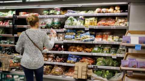 A customer shops for groceries at an M&S supermarket in London, UK