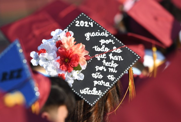 A graduate’s decorated cap thanks her family for everything during...