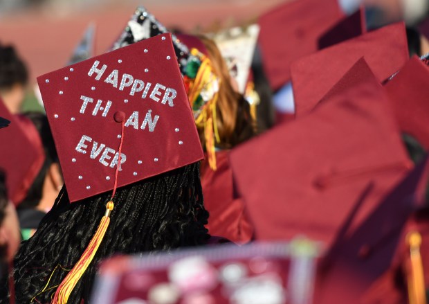 A graduate’s decorated cap shares her feelings during the San...