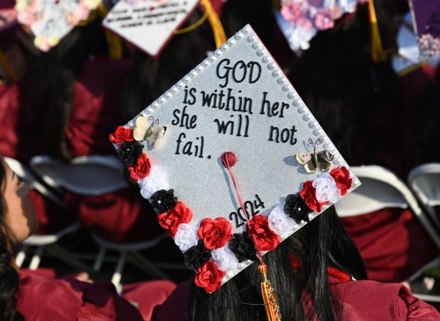 A graduate’s cap expresses her faith during the San Bernardino’s...