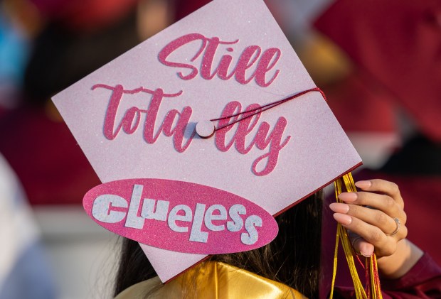 “Still Totally Clueless” is the slogan on a decorated cap...