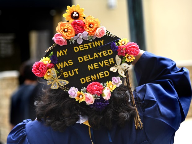 Elizabeth Gonzalez shows her decorated cap after the California Baptist...