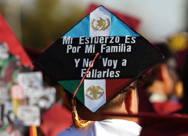 A graduate’s decorated cap says, “My strength is from my...