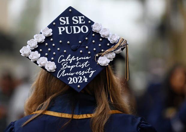 Cielo Rodriguez displays a decorated graduation cap before graduating Monday,...