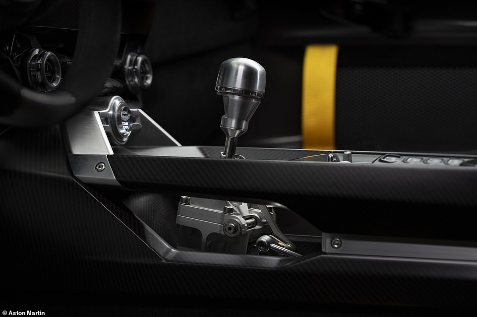 To highlight the mechanical nature of the manual gearbox, a cutaway in the transmission tunnel exposes the gear linkage running rearward to the six-speed transaxle