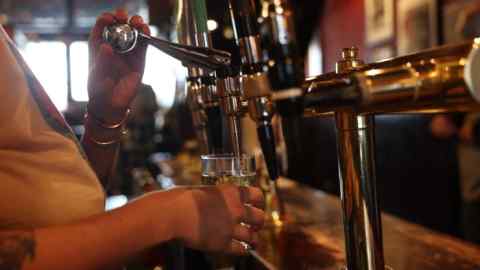 A bartender pulls a pint