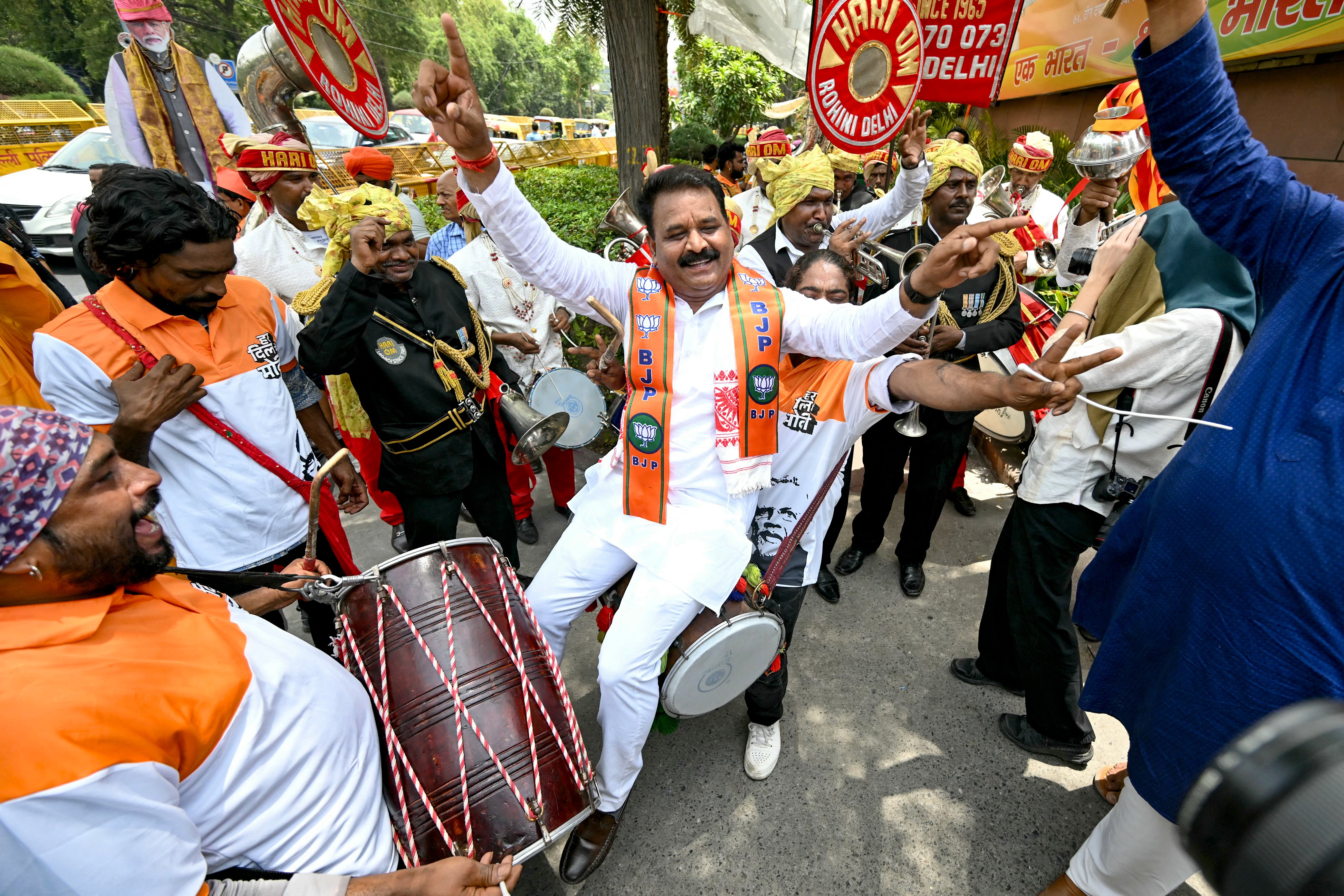 Supporters of Bharatiya Janata Party (BJP) celebrate vote counting results for India’s general election outside the BJP headquarter in New Delhi