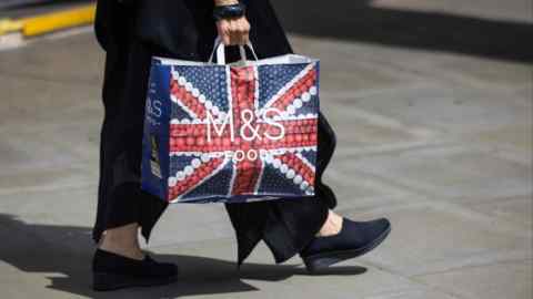 Person carries an M&S branded bag