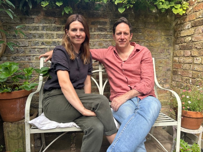 The couple sit on a garden chair