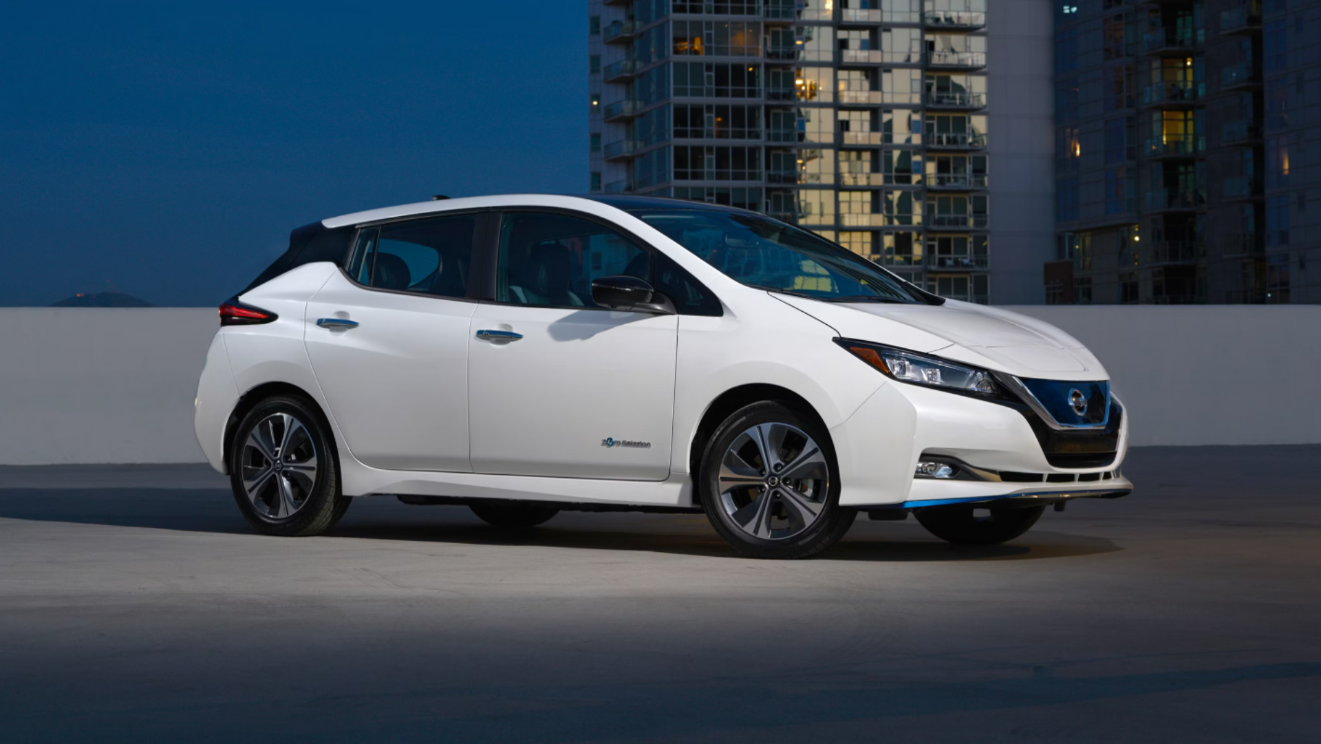 Side profile shot of a white 2019 Nissan Leaf.