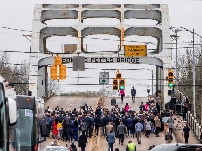 A group of people about to cross a bridge