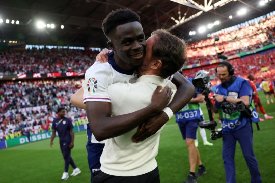 Bukayo Saka hugs Gareth Southgate