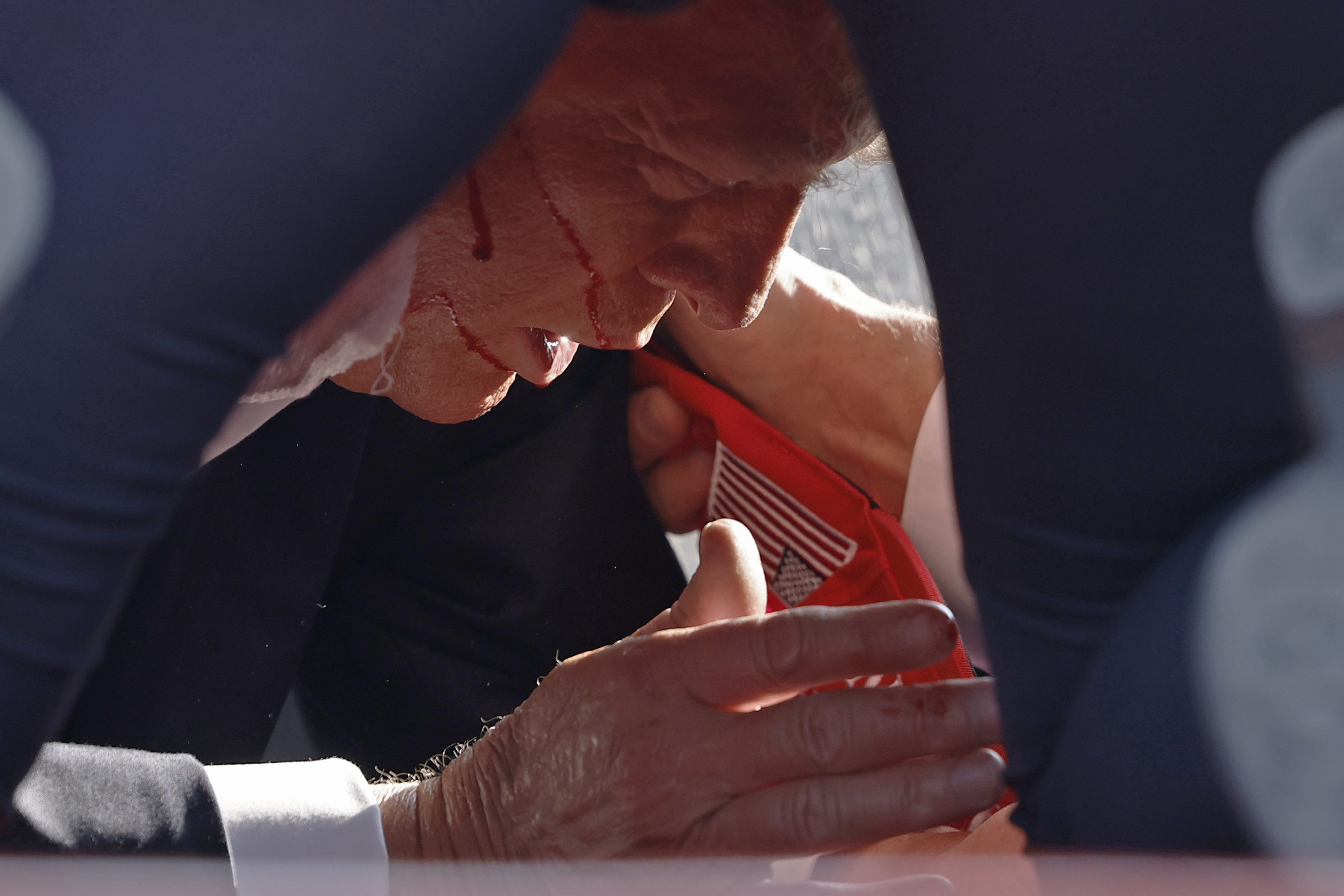 The former president was seen dropping to the floor after gunfire began