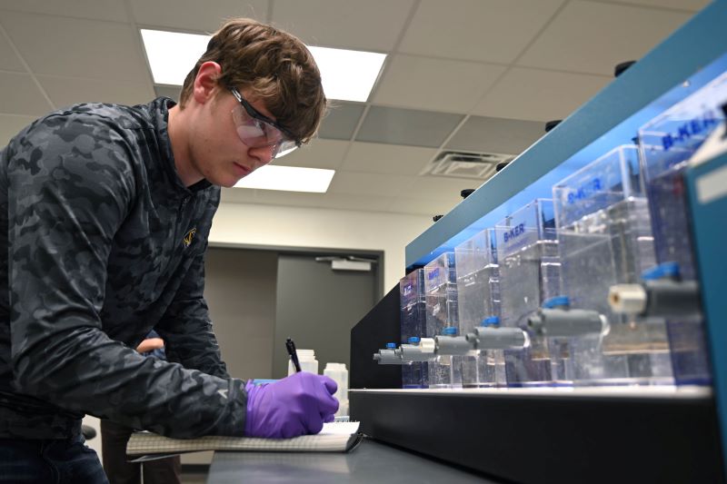 Student working with environmental engineering technology in lab