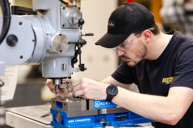 Student working with machine in lab