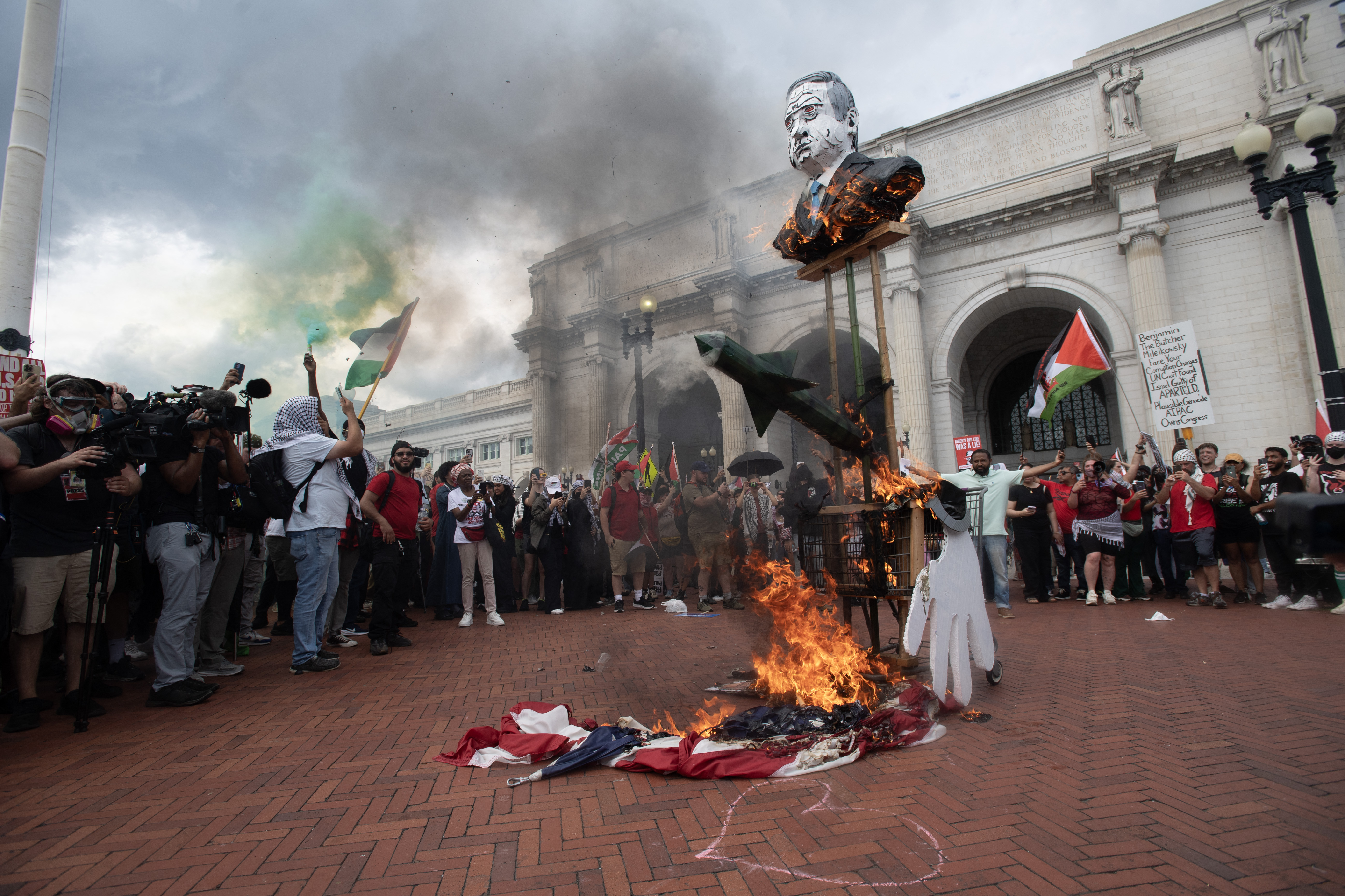 Protesters burn an American Flag outside of Union Station in Washington DC