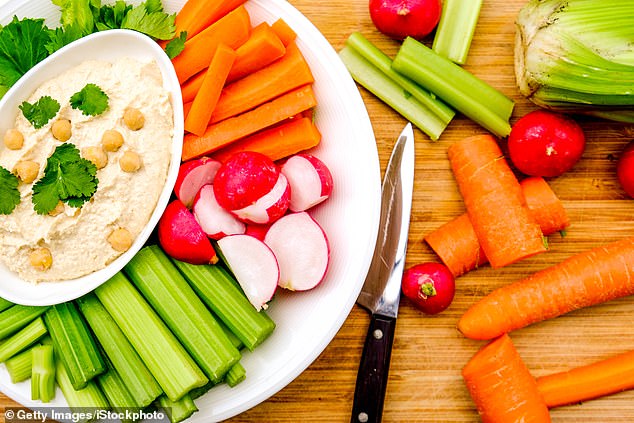 Snacking on hardboiled eggs, apple slices with a small helping of nut butter or some hummus and carrots will keep you feeling 'satisfied' and fuller for longer, Ms Diamond says