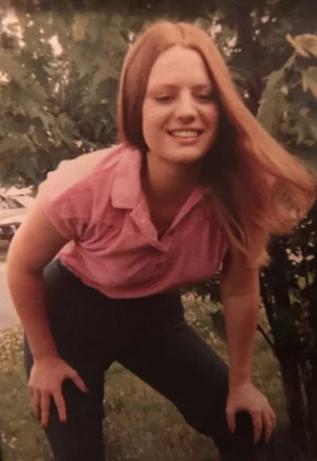 woman smiling with hands on knees