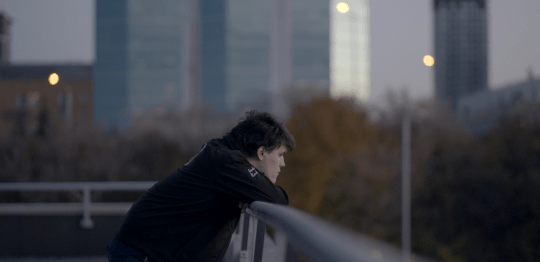 Joshua Barbeau looking over a rooftop