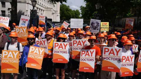 PA Media Junior doctors protesting opposite Downing Street, London. 