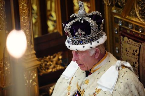 King Charles III, wearing the Imperial State Crown and the Robe of State, reads the King's Speech during the State Opening of Parliament, 17 July 2024