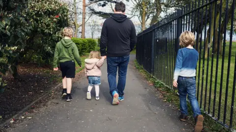 Getty Images A man with three children