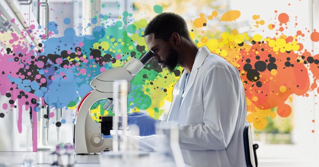 Scientist looking through a microscope in the lab