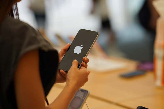 A customer holds an iPhone 15 pro which displayed the Apple logo at Apple Store in Hong Kong.