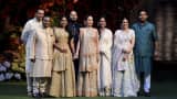 (L to R) Anand Piramal, Mukesh Ambani, Radhika Merchant, Anant Ambani, Neeta Ambani, Isha Ambani Piramal, Shloka Mehta Ambani and Akash Ambani pose for the media during a photo opportunity at the red carpet ceremony to celebrate the engagement of Anant and Radhika at Ambani's Antilia residence in Mumbai, India, on Jan. 19, 2023.