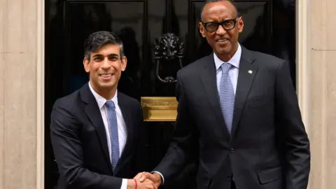 Getty Images Rwandan President Paul Kagame (R) is greeted by Britain's Prime Minister Rishi Sunak (L) as he arrives at Downing Street on April 09, 2024. 